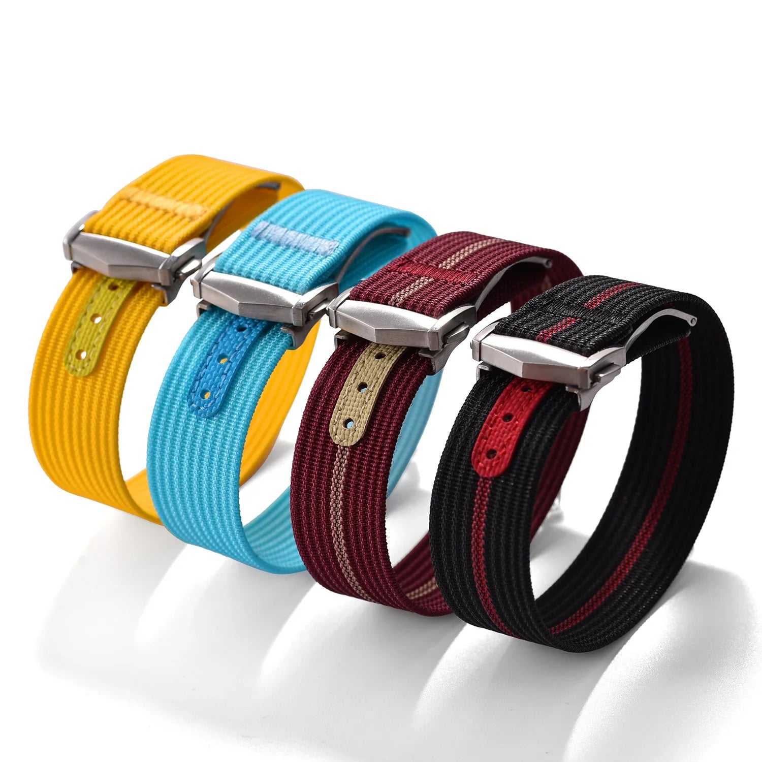 Quatre bracelets de montre textiles colorés pour montres de luxe sur fond blanc, misterchrono.com